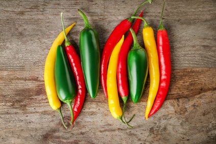 Colorful peppers on wooden background